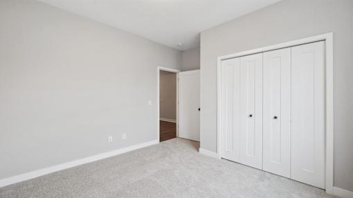 A room with a white door and a white cabinet.