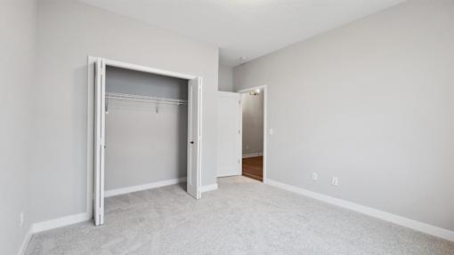 A white room with a large open closet door.
