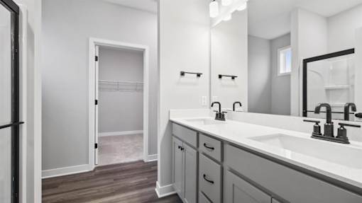 A bathroom with a white sink and a white door.