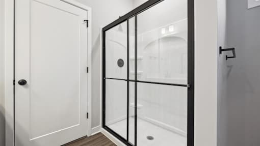 A white door with a black handle and a black frame.