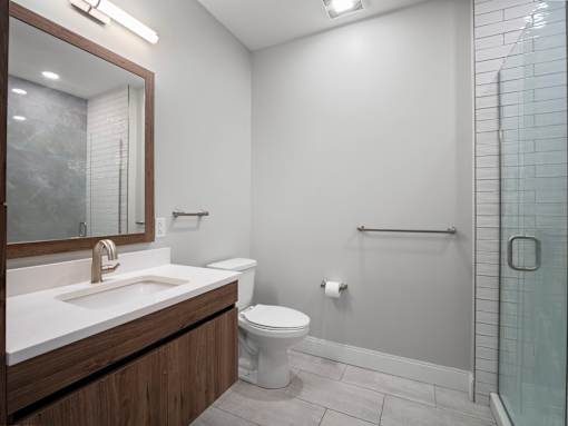 A bathroom with a toilet, sink, and shower.