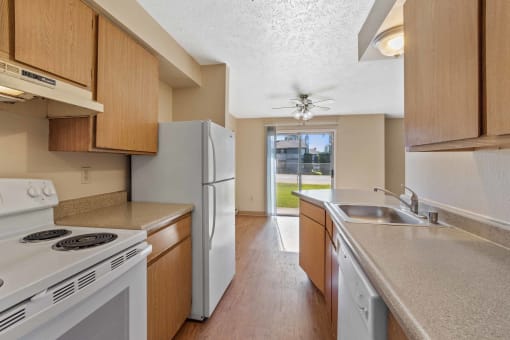 a kitchen with white appliances and wooden cabinets