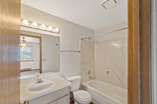 a bathroom with a sink and a tub and a shower