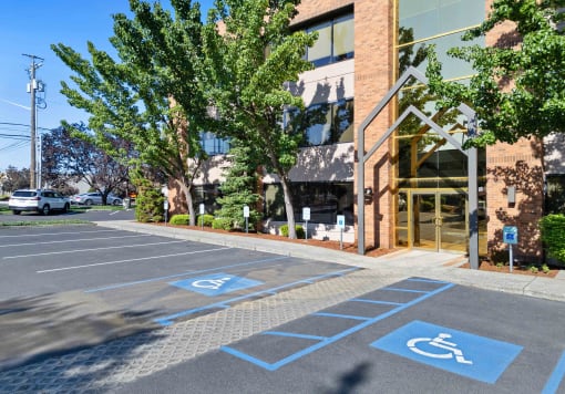 a parking lot in front of a building with disabled parking spaces