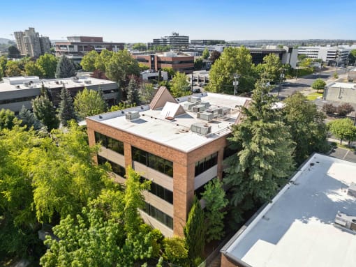 an aerial view of a building with a city in the background