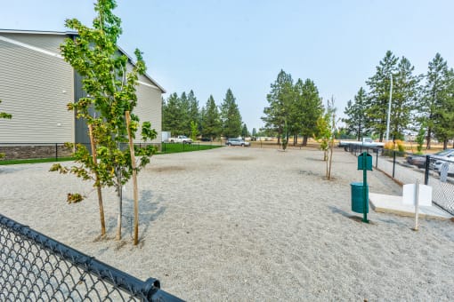 dog park with a large gravel area and trees