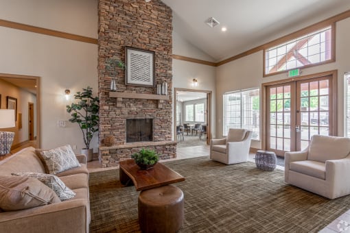 a living room with a stone fireplace and a couch