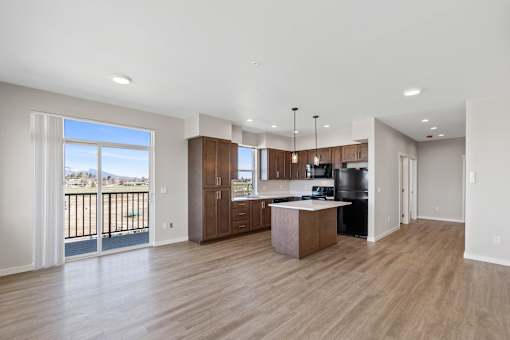 A spacious kitchen with wooden floors and modern appliances.
