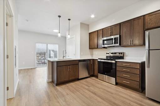 A modern kitchen with wooden cabinets and stainless steel appliances.