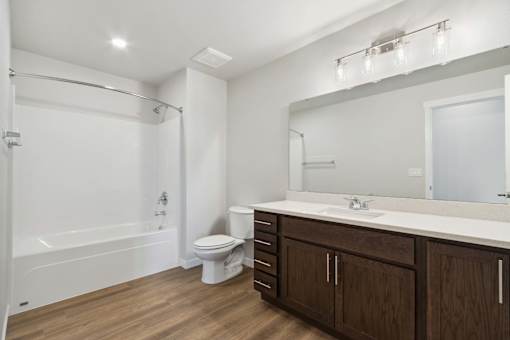 A white bathroom with a toilet, sink, and bathtub.