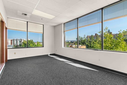 an empty office space with large windows and a city view