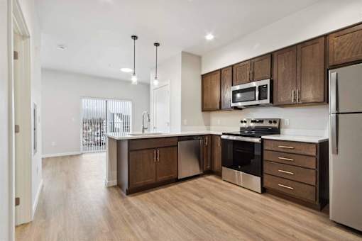 A modern kitchen with wooden cabinets and stainless steel appliances.