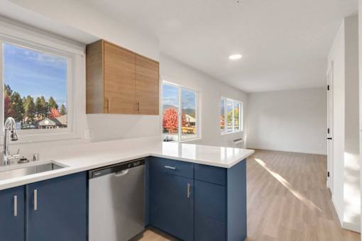 A kitchen with blue cabinets and a white countertop.