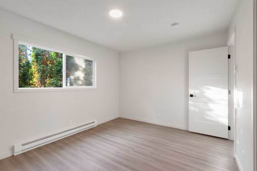 A room with a window and a door.