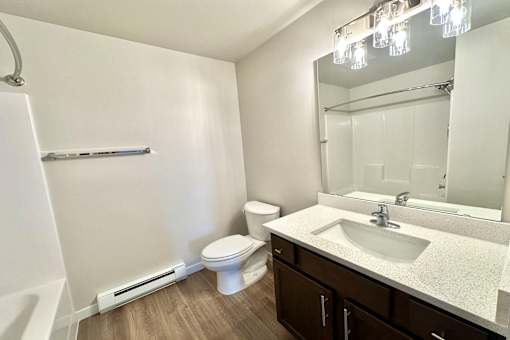 A white toilet sits next to a sink in a bathroom.