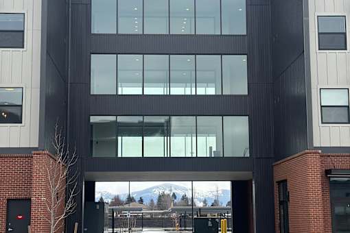 A modern building with a large glass window entrance.