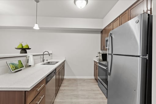A modern kitchen with a refrigerator on the right side.