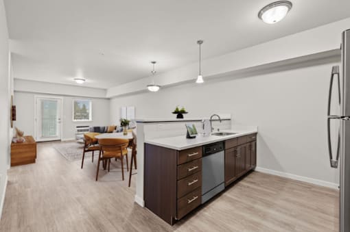 A modern kitchen with a dining table and chairs.