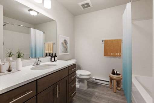 A bathroom with a white sink and a white toilet.