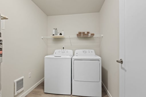 A small laundry room with a washer and dryer.