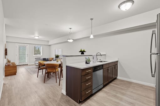 A modern kitchen with a dining table and chairs.