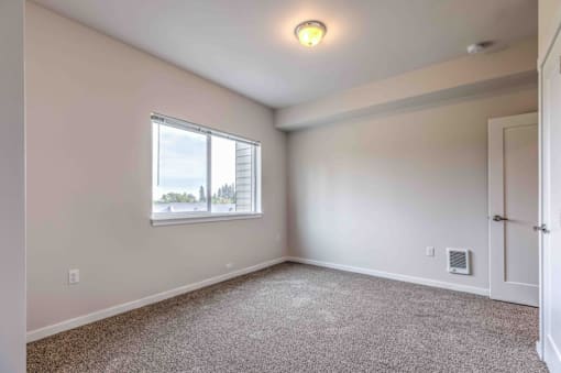 A room with a window and a door.