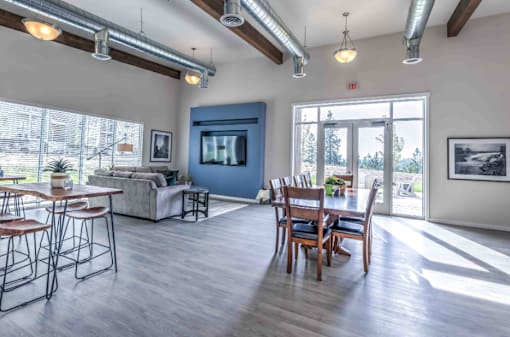 A spacious living room with a dining area and a television.