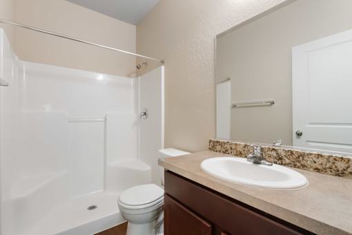 A white toilet sits next to a sink in a bathroom.