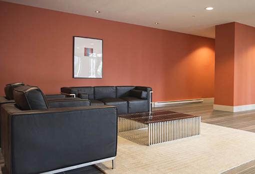 a living room with black couches and a coffee table