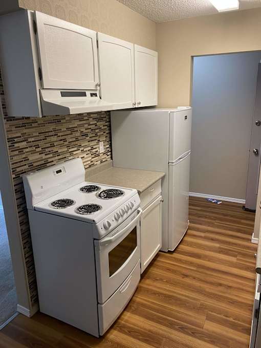 a kitchen with a stove and a refrigerator