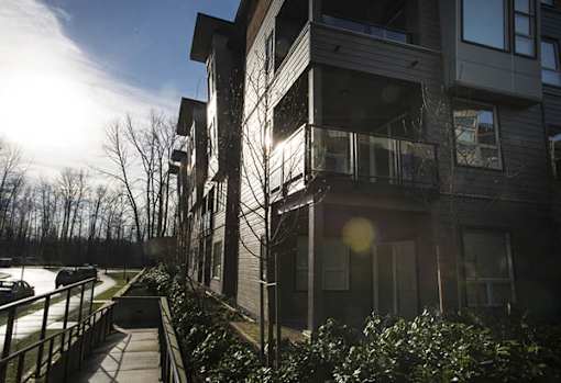 a row of apartment buildings on a sunny day
