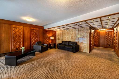 A room with wooden walls and a carpeted floor.
