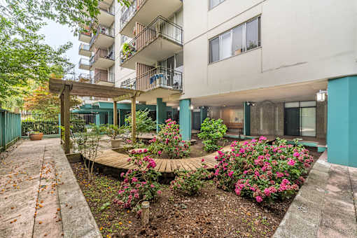 A building with a garden in front of it.