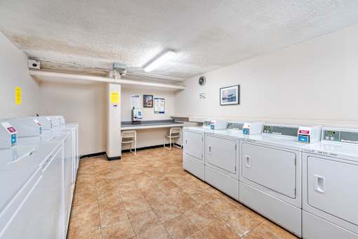 A laundry room with washers and dryers.
