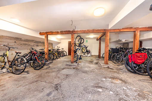 A bike rack with bicycles parked in a garage.