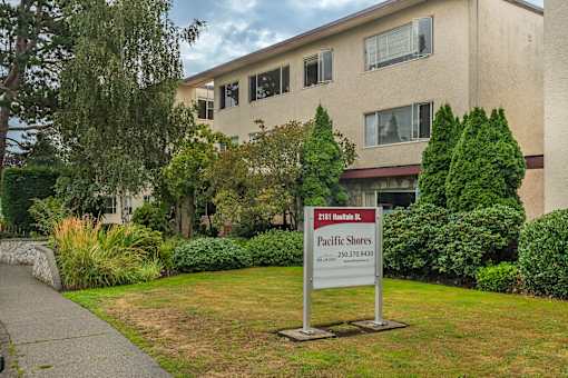 A sign for Pacific Shores is in front of a building.