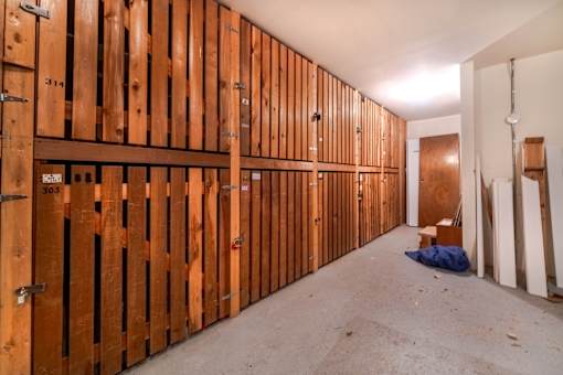 A room under construction with wooden walls and a door on the right.