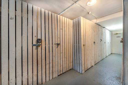 A long hallway with wooden walls and doors.