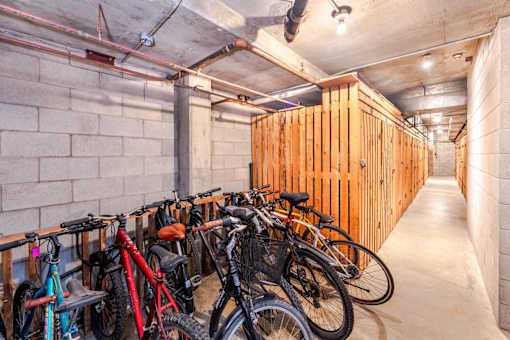 A bike parking area with bikes of various colors.