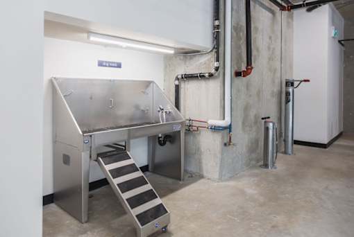A stainless steel industrial machine with a metal staircase leading to it.