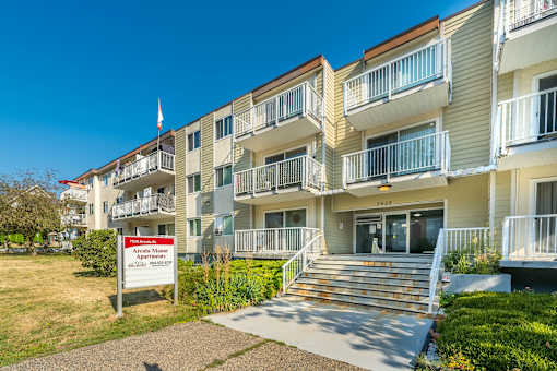 Apartment building with a sign in front that says "Apartments for sale".