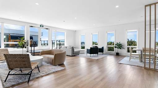 A spacious living room with wooden floors and furniture.