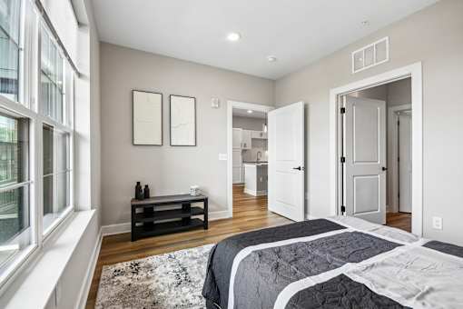 A bedroom with a large bed and a window.