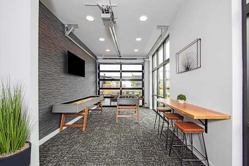 an open office space with tables and chairs and a large window