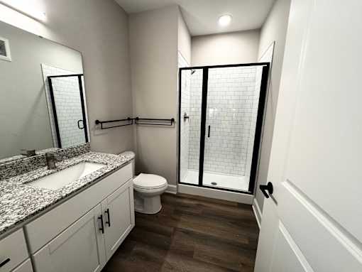 A bathroom with a sink, toilet, and shower.