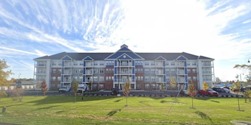 A large building with a grassy area in front of it.