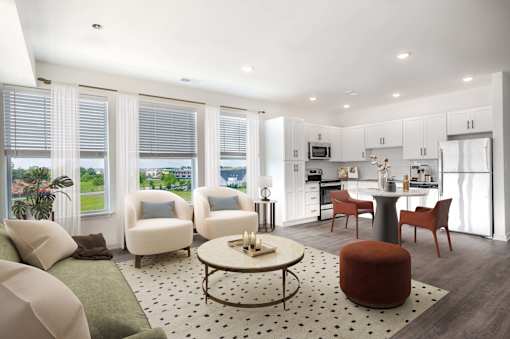 A modern living room with a green couch, a coffee table, and a dining table.