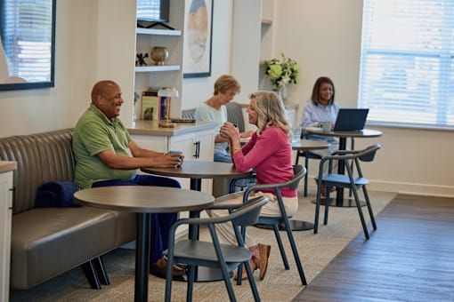 A group of people are sitting around a table in a room.
