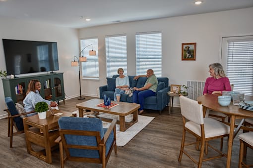 A group of people are sitting in a living room.