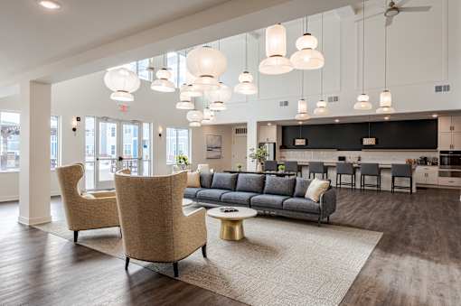 A living room with a grey couch and a white ceiling.